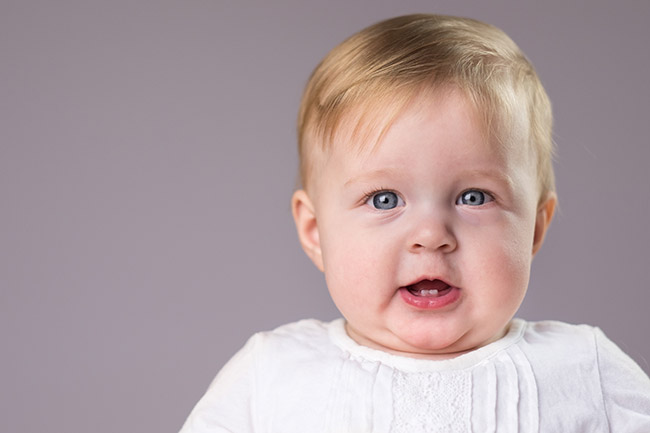 baby with teeth smiling
