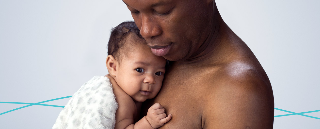 Image of a dad holding his baby