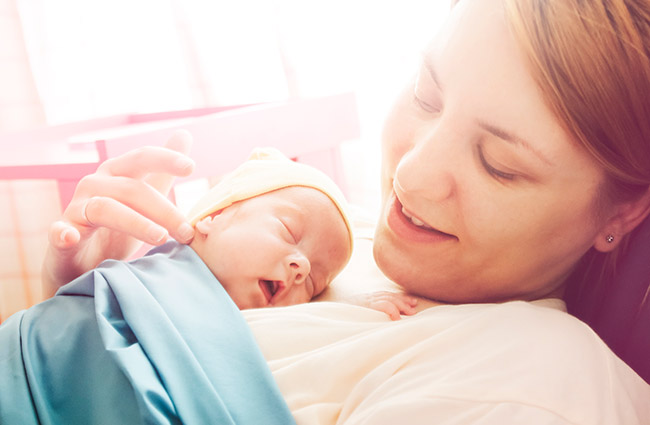 Mother with baby resting on her chest