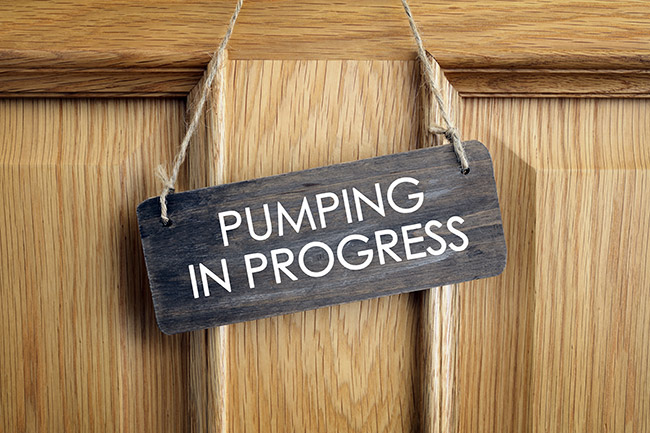 Sign on a door that says pumping in progress